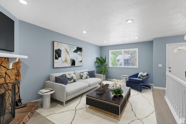 1410 S 50 W, Farmington, UT 84025 - living room featuring light wood finished floors, a textured ceiling, and recessed lighting