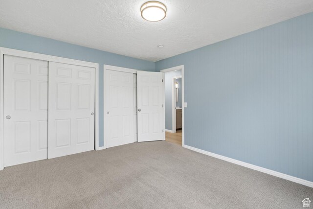 1410 S 50 W, Farmington, UT 84025 - unfurnished bedroom featuring carpet flooring, multiple closets, and a textured ceiling