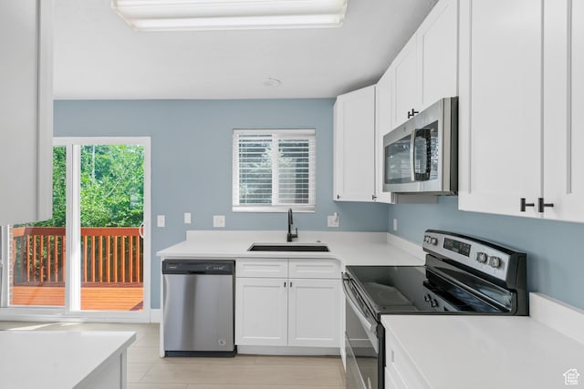 1410 S 50 W, Farmington, UT 84025 - kitchen featuring appliances with stainless steel finishes, light tile patterned floors, white cabinetry, and light countertops