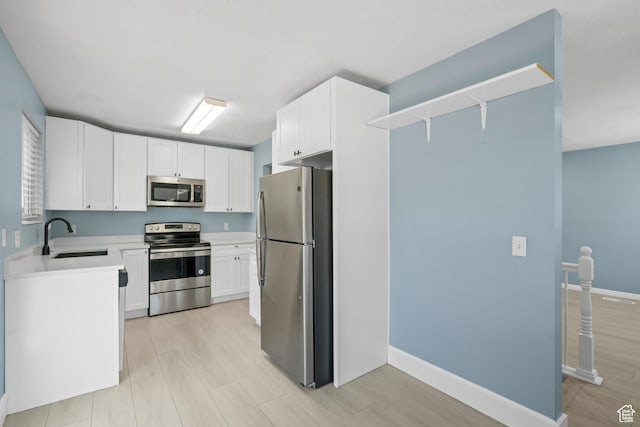 1410 S 50 W, Farmington, UT 84025 - kitchen with appliances with stainless steel finishes, light wood-style floors, light countertops, and white cabinets