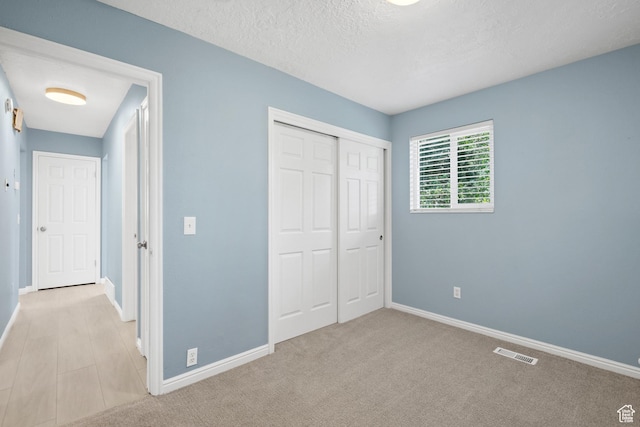 1410 S 50 W, Farmington, UT 84025 - unfurnished bedroom with a closet, a textured ceiling, and carpet flooring