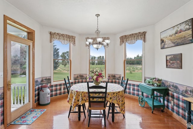 3136 W 2400th St S, Charleston, UT 84032 - dining room featuring a chandelier, wood finished floors, plenty of natural light, and a wainscoted wall