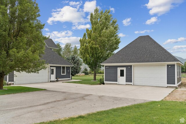 3136 W 2400th St S, Charleston, UT 84032 - view of home's exterior featuring a shingled roof, a lawn, and a detached garage