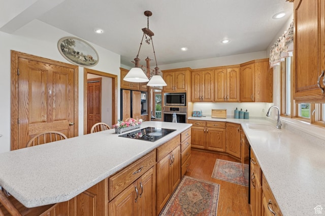 3136 W 2400th St S, Charleston, UT 84032 - kitchen featuring appliances with stainless steel finishes, a kitchen island, wood finished floors, recessed lighting, and brown cabinets