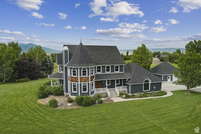 3136 W 2400th St S, Charleston, UT 84032 - rear view of house with covered porch, driveway, a yard, and a shingled roof