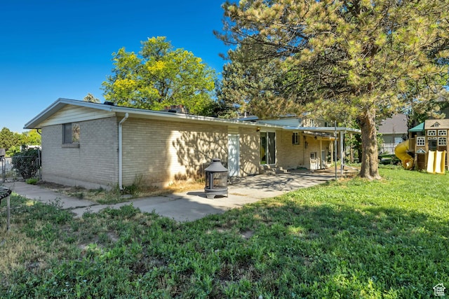 1261 E Sandra Cir, Murray, UT 84121 - rear view of house with brick siding and a patio