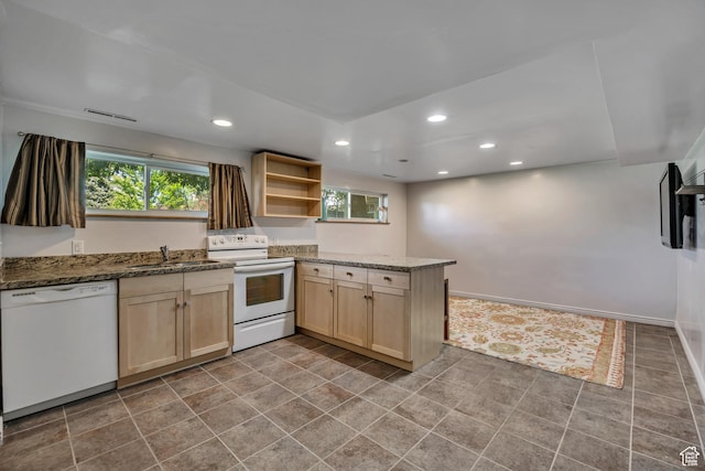 1261 E Sandra Cir, Murray, UT 84121 - kitchen with white appliances, light brown cabinets, plenty of natural light, a peninsula, and recessed lighting