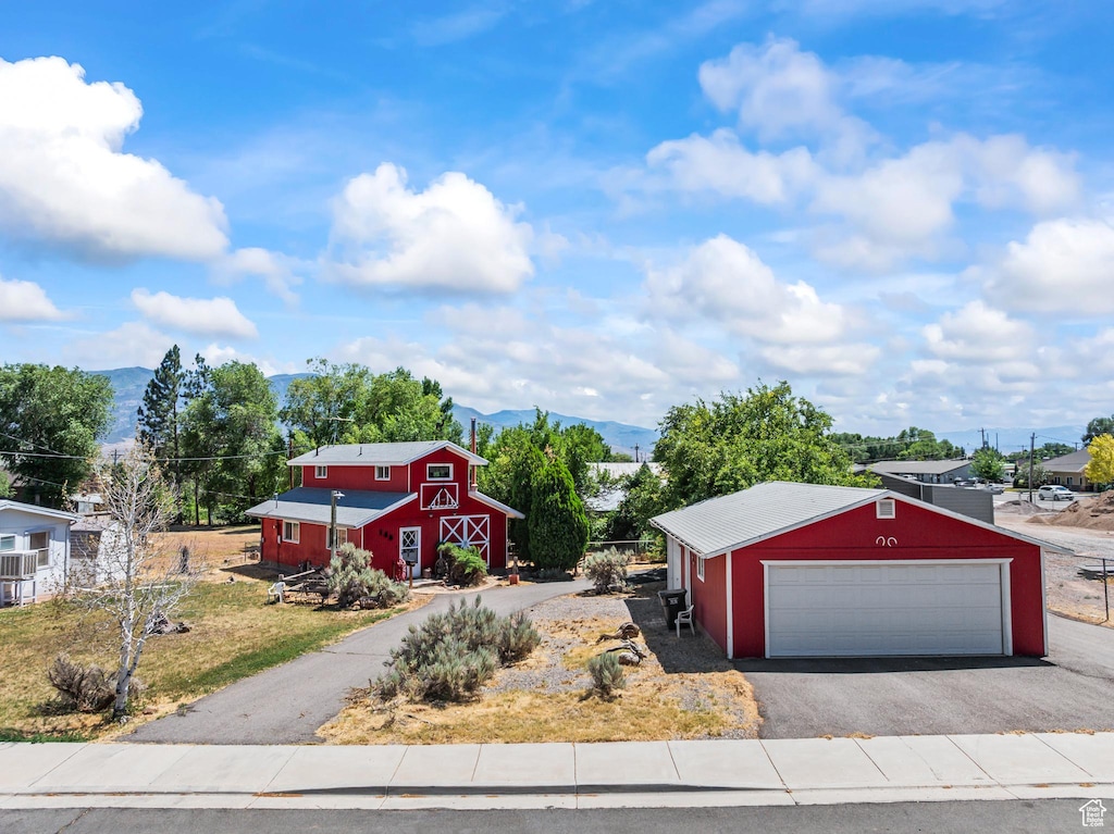 140 E 200 S, Richfield, UT 84701 - view of front of house featuring a barn, an outbuilding, a mountain view, and a garage