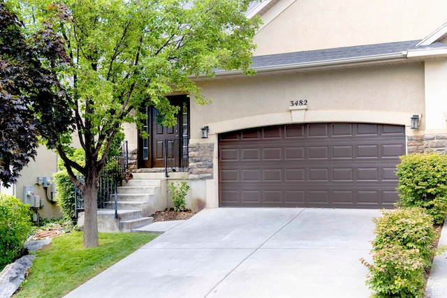 3482 W Plymouth Rock Cv, Lehi, UT 84043 - view of front of house featuring stone siding, stucco siding, concrete driveway, and an attached garage