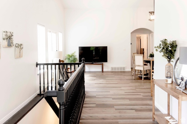 3482 W Plymouth Rock Cv, Lehi, UT 84043 - hallway with arched walkways, an upstairs landing, wood finished floors, and healthy amount of natural light