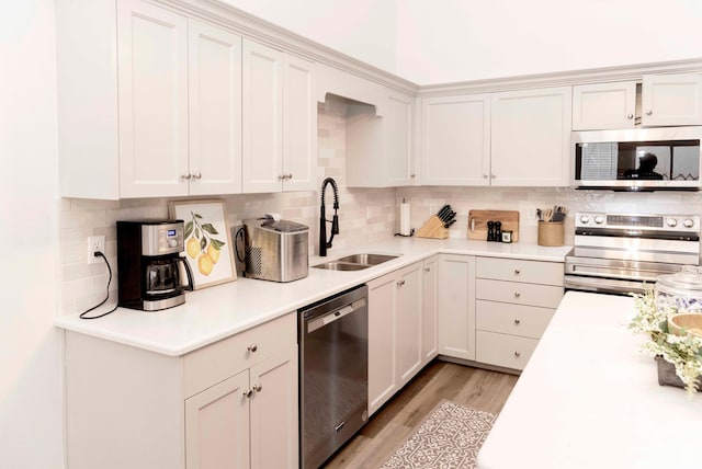 3482 W Plymouth Rock Cv, Lehi, UT 84043 - kitchen featuring stainless steel appliances, backsplash, light countertops, and light wood-style floors
