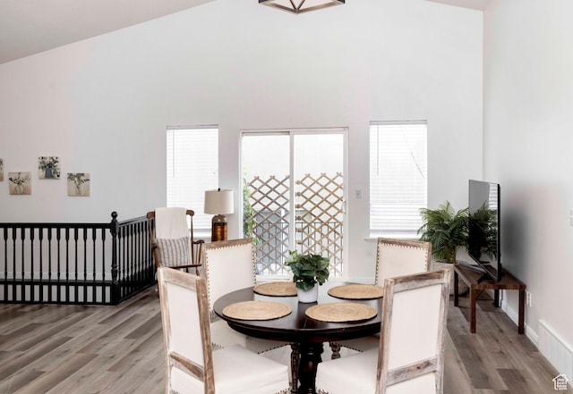 3482 W Plymouth Rock Cv, Lehi, UT 84043 - dining area with light wood-type flooring, plenty of natural light, and a towering ceiling