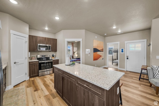 1468 S Sage Ct S Unit 13, Kanab, UT 84741 - kitchen featuring appliances with stainless steel finishes, light wood-type flooring, a kitchen island, recessed lighting, and dark brown cabinetry