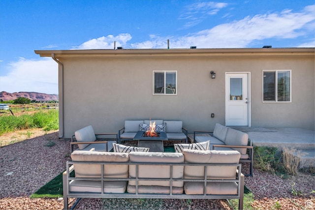 1468 S Sage Ct S Unit 13, Kanab, UT 84741 - back of property featuring an outdoor living space with a fire pit, stucco siding, and a patio area