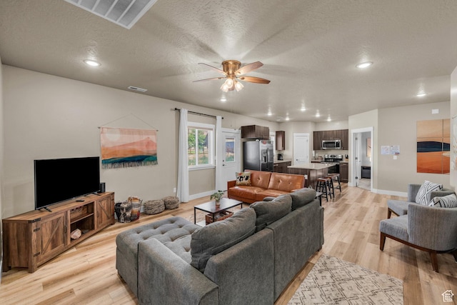 1468 S Sage Ct S Unit 13, Kanab, UT 84741 - living area featuring a ceiling fan, light wood finished floors, a textured ceiling, and recessed lighting