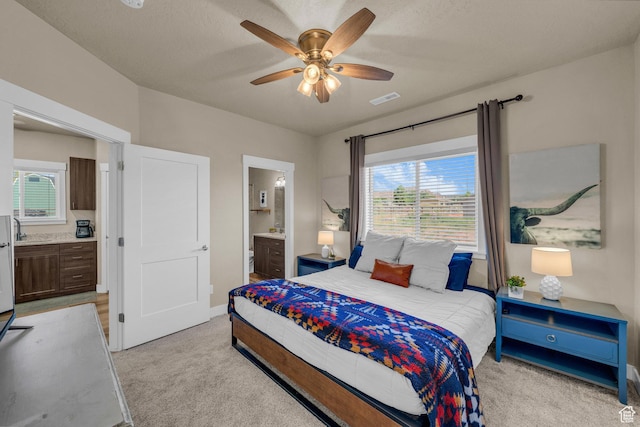 1468 S Sage Ct S Unit 13, Kanab, UT 84741 - bedroom featuring light carpet, ensuite bathroom, multiple windows, and ceiling fan