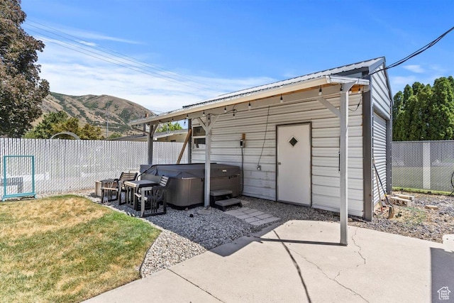 158 N 800 E, Brigham City, UT 84302 - view of outbuilding with a hot tub, a fenced backyard, and a mountain view