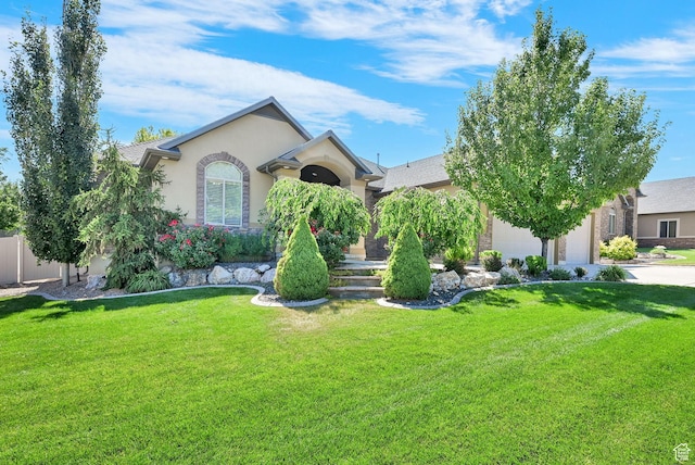 7496 S 1740 E, South Weber, UT 84405 - view of front of house featuring stucco siding, a front yard, driveway, and a garage