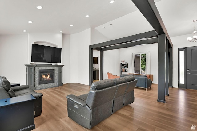7496 S 1740 E, South Weber, UT 84405 - living room featuring light wood finished floors, a chandelier, a glass covered fireplace, and recessed lighting