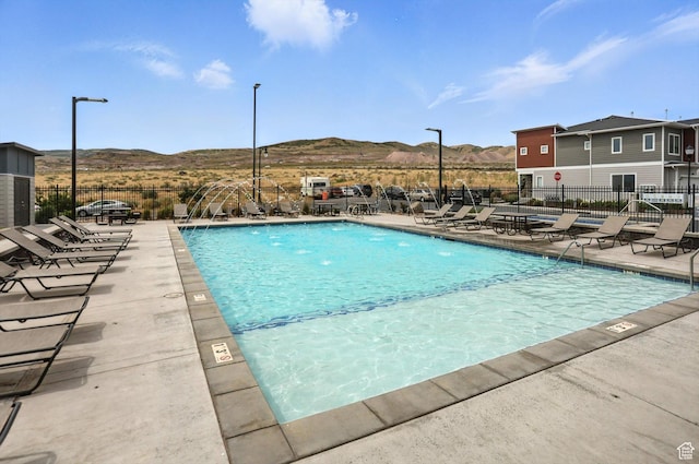 3724 W Soft Whisper Way, Herriman, UT 84096 - community pool with a mountain view and a patio area