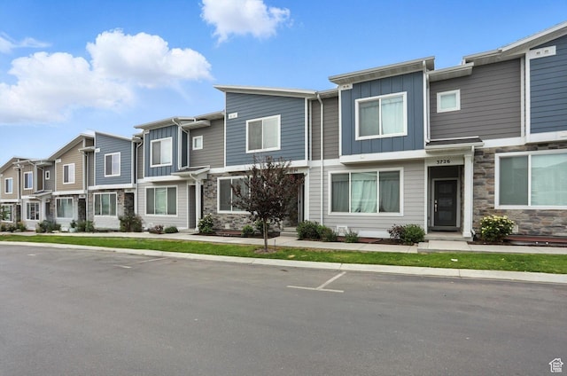 3724 W Soft Whisper Way, Herriman, UT 84096 - townhome / multi-family property featuring board and batten siding, stone siding, and a residential view