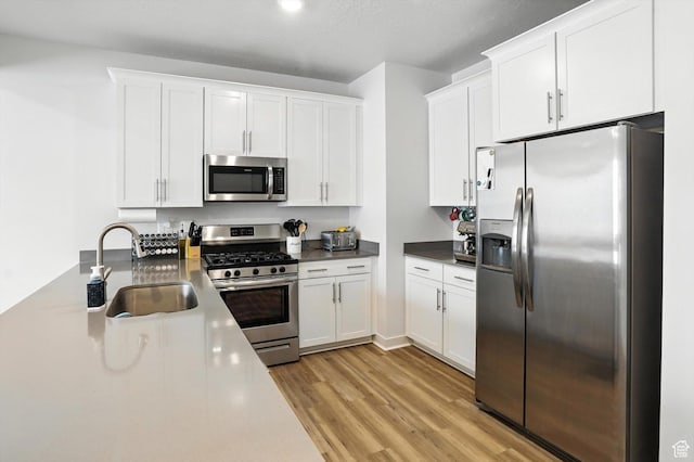 3724 W Soft Whisper Way, Herriman, UT 84096 - kitchen with appliances with stainless steel finishes, light wood finished floors, and white cabinets