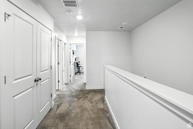 3724 W Soft Whisper Way, Herriman, UT 84096 - hallway with dark colored carpet, an upstairs landing, a textured ceiling, and recessed lighting