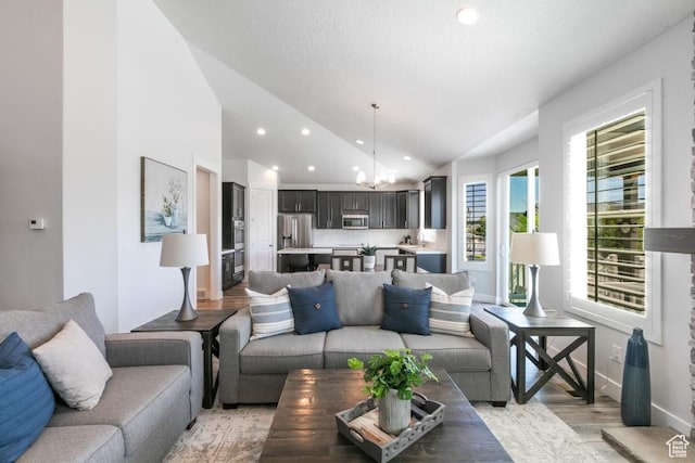 11709 S 2610 W, Riverton, UT 84065 - living area featuring vaulted ceiling, a chandelier, light wood-style floors, and recessed lighting
