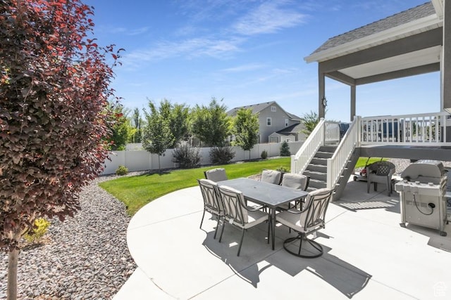 11709 S 2610 W, Riverton, UT 84065 - fenced backyard featuring outdoor dining area, a grill, a patio, and stairway