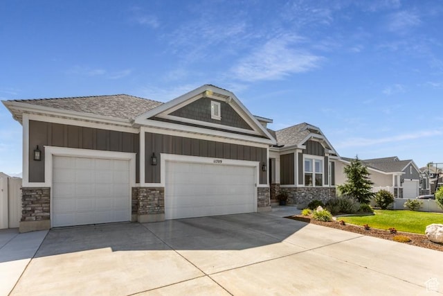 11709 S 2610 W, Riverton, UT 84065 - craftsman-style home with board and batten siding, a garage, and stone siding