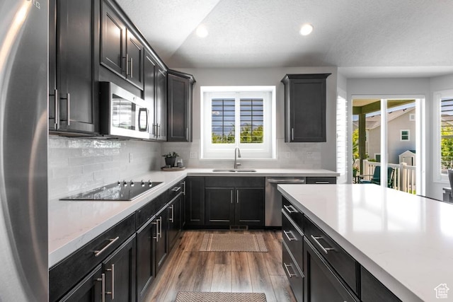11709 S 2610 W, Riverton, UT 84065 - kitchen with stainless steel appliances, wood finished floors, light countertops, recessed lighting, and backsplash