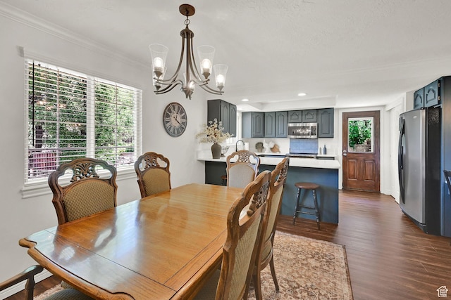 2779 E 3575 N, Layton, UT 84040 - dining area featuring dark wood finished floors, a chandelier, crown molding, and recessed lighting