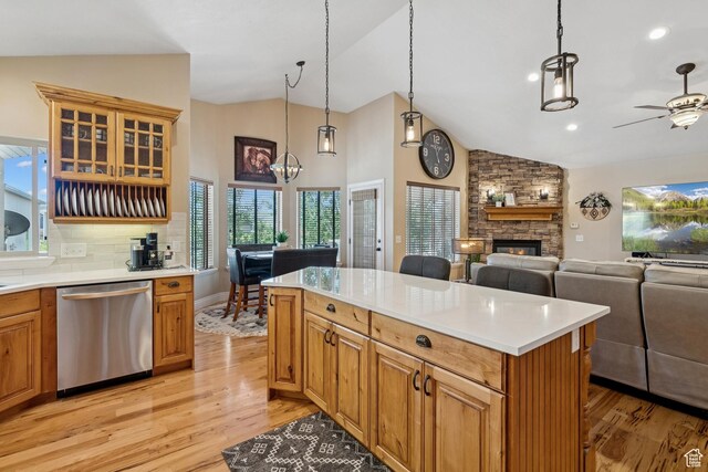 294 W Willow Ct Unit 12, Francis, UT 84036 - kitchen with dishwasher, vaulted ceiling, light wood-style flooring, a stone fireplace, and plenty of natural light