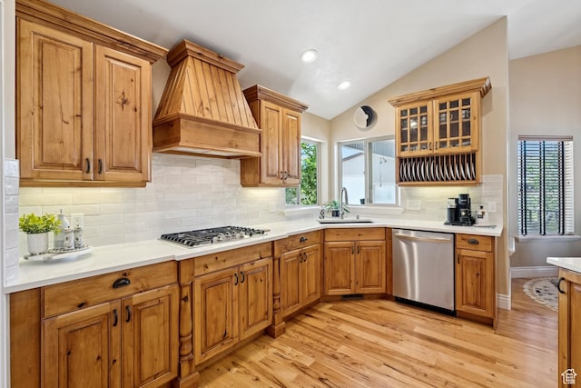 294 W Willow Ct Unit 12, Francis, UT 84036 - kitchen featuring appliances with stainless steel finishes, premium range hood, lofted ceiling, healthy amount of natural light, and light wood finished floors