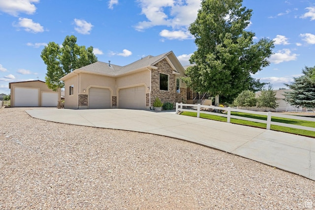 294 W Willow Ct Unit 12, Francis, UT 84036 - view of front facade featuring stone siding, driveway, stucco siding, and a garage