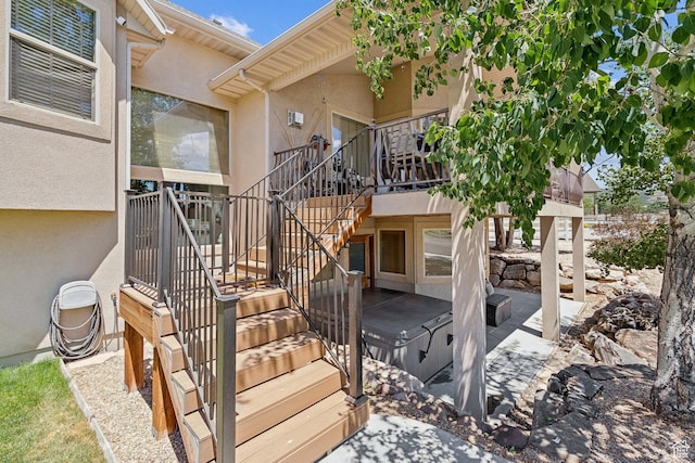 294 W Willow Ct Unit 12, Francis, UT 84036 - view of exterior entry with stucco siding, a patio area, and a hot tub