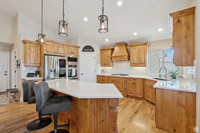 294 W Willow Ct Unit 12, Francis, UT 84036 - kitchen with stainless steel appliances, premium range hood, a center island, backsplash, and light wood-style floors