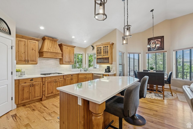 294 W Willow Ct Unit 12, Francis, UT 84036 - kitchen with stainless steel dishwasher, gas stovetop, premium range hood, light wood finished floors, and light countertops