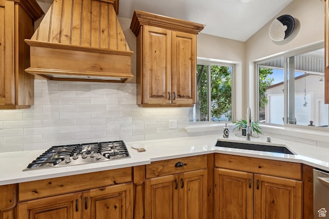 294 W Willow Ct Unit 12, Francis, UT 84036 - kitchen featuring appliances with stainless steel finishes, custom range hood, decorative backsplash, brown cabinets, and lofted ceiling