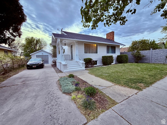 432 S 100 E, Provo, UT 84606 - bungalow-style house with a chimney, a garage, an outdoor structure, concrete driveway, and a shingled roof