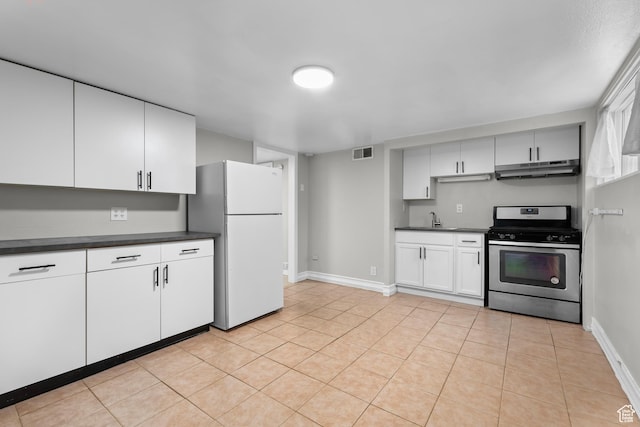 432 S 100 E, Provo, UT 84606 - kitchen featuring stainless steel gas range oven, freestanding refrigerator, dark countertops, under cabinet range hood, and white cabinets