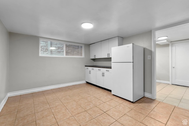 432 S 100 E, Provo, UT 84606 - kitchen featuring freestanding refrigerator, dark countertops, white cabinets, and light tile patterned flooring