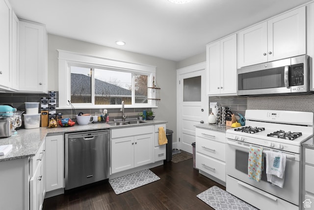 432 S 100 E, Provo, UT 84606 - kitchen featuring stainless steel appliances, recessed lighting, dark wood finished floors, decorative backsplash, and white cabinets