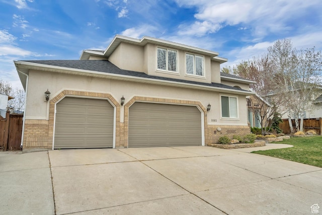 1885 E 10225 S, Sandy, UT 84092 - view of front facade featuring brick siding, concrete driveway, stucco siding, and a shingled roof
