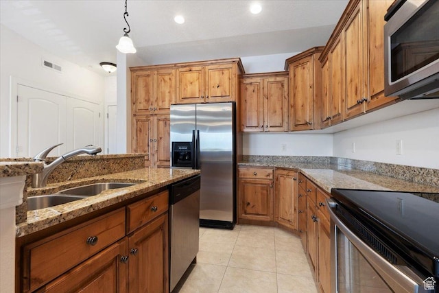 983 W 1055 N Unit 816, Orem, UT 84057 - kitchen with appliances with stainless steel finishes, brown cabinetry, light stone counters, pendant lighting, and light tile patterned floors