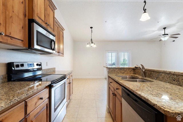 983 W 1055 N Unit 816, Orem, UT 84057 - kitchen with stainless steel appliances, brown cabinetry, decorative light fixtures, light stone countertops, and light tile patterned floors
