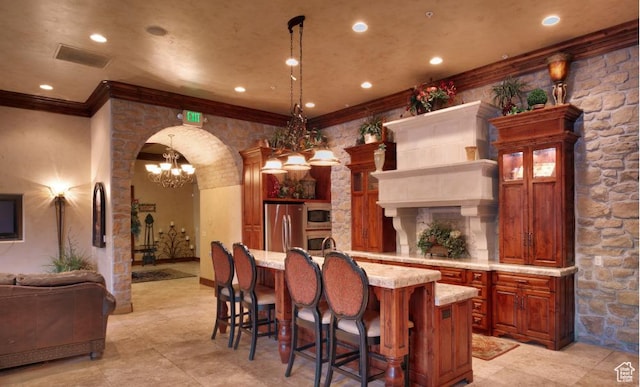983 W 1055 N Unit 816, Orem, UT 84057 - kitchen featuring appliances with stainless steel finishes, arched walkways, a breakfast bar, a center island with sink, and pendant lighting