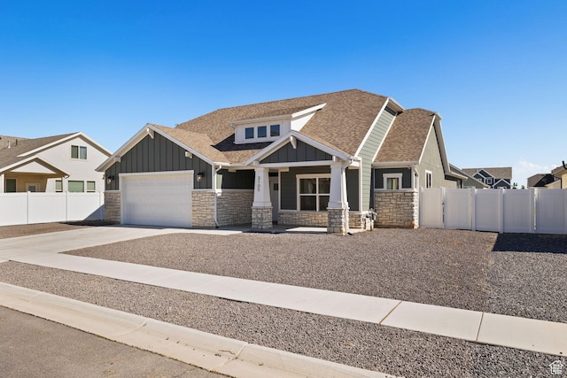 3105 W 3150 N, Plain City, UT 84404 - craftsman-style home featuring board and batten siding, stone siding, an attached garage, roof with shingles, and covered porch