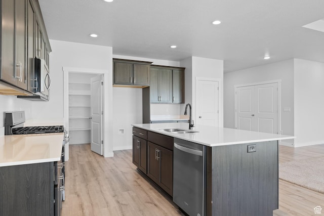 3105 W 3150 N, Plain City, UT 84404 - kitchen with stainless steel appliances, light wood finished floors, a kitchen island with sink, recessed lighting, and light countertops