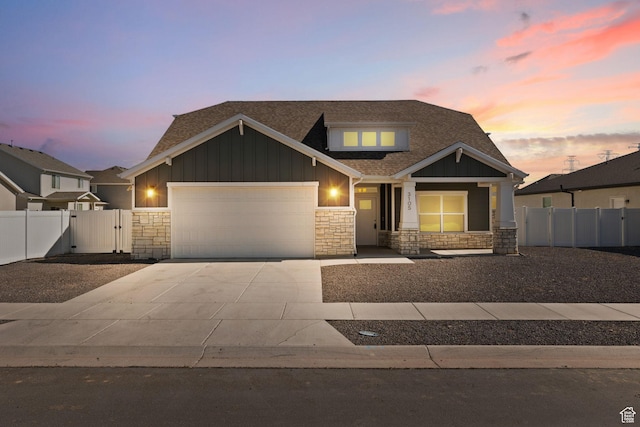 3105 W 3150 N, Plain City, UT 84404 - view of front of house featuring stone siding, board and batten siding, a garage, driveway, and a shingled roof